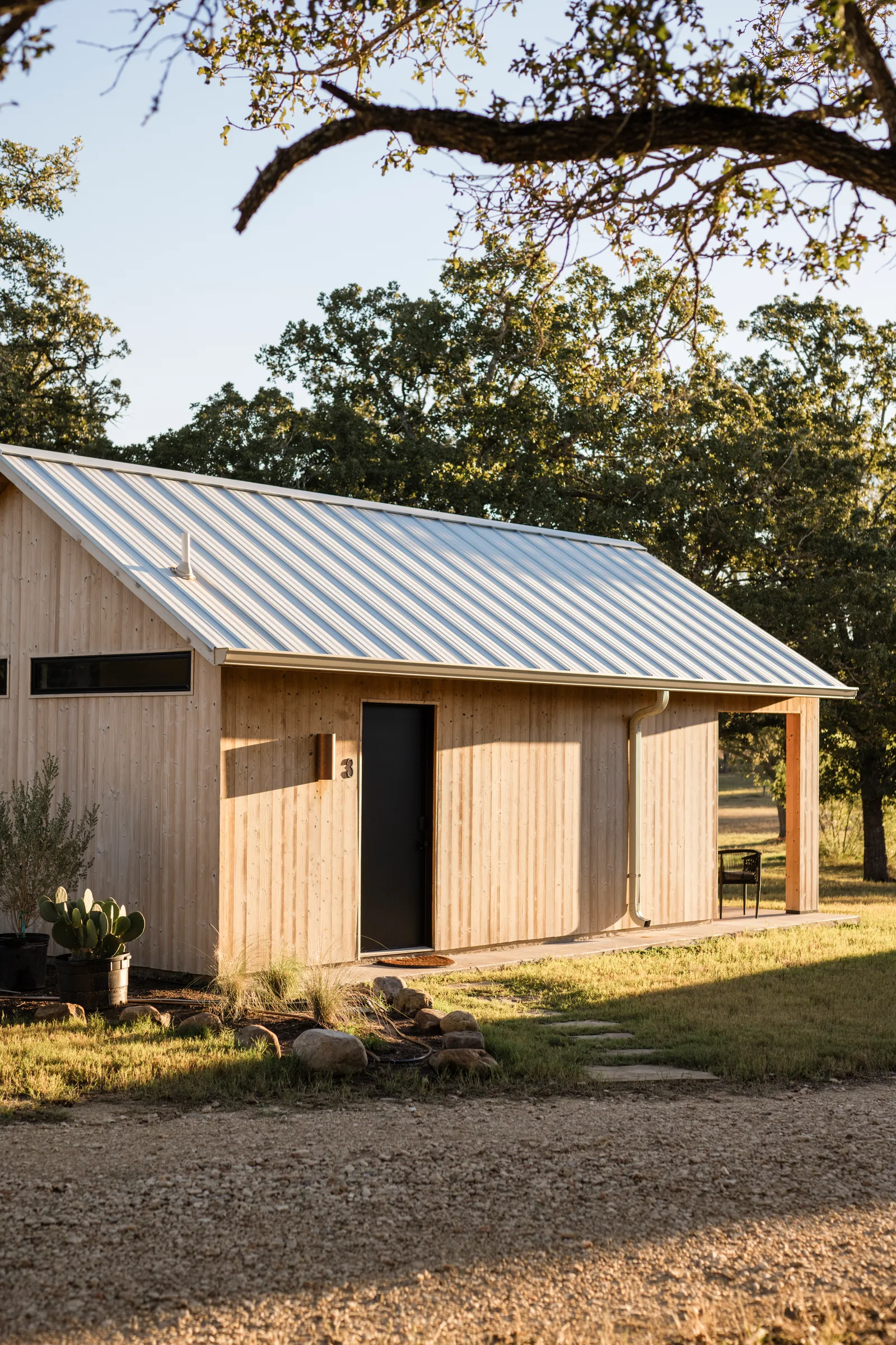 Serana cabin entry framed by oak branches