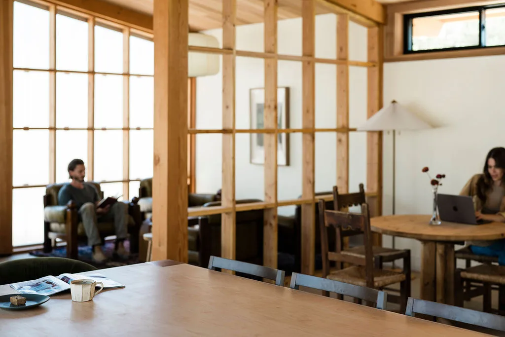 Guests working around the Serana lodge dining table